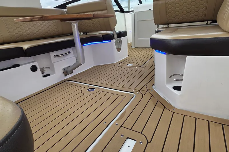 Slide: The Image of Luxurious interior of 2020 Sea Ray SDX 250 Outboard with elegant seating and wood flooring. - 11