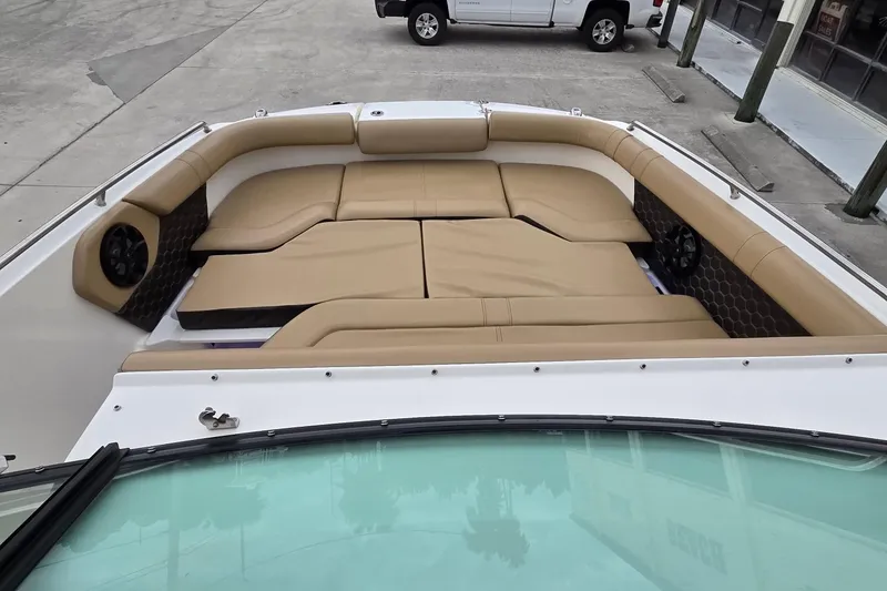 Slide: The Image of 2020 Sea Ray SDX 250 Outboard boat with spacious tan seating area. - 12