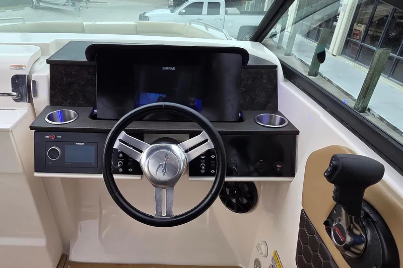 Slide: The Image of 2020 Sea Ray SDX 250 Outboard helm with steering wheel and controls. - 15