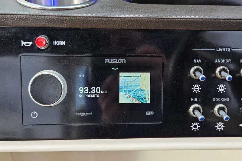 Slide: The Image of 2020 Sea Ray SDX 250 Outboard dashboard with Fusion stereo and control switches. - 19