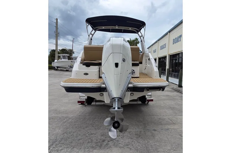 Slide: The Image of 2020 Sea Ray SDX 250 Outboard boat, rear view with outboard motor, parked outdoors. - 2