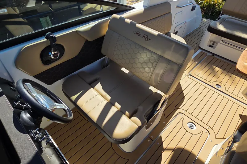 Slide: The Image of 2020 Sea Ray SDX 250 Outboard interior with tan seating and steering wheel. - 23