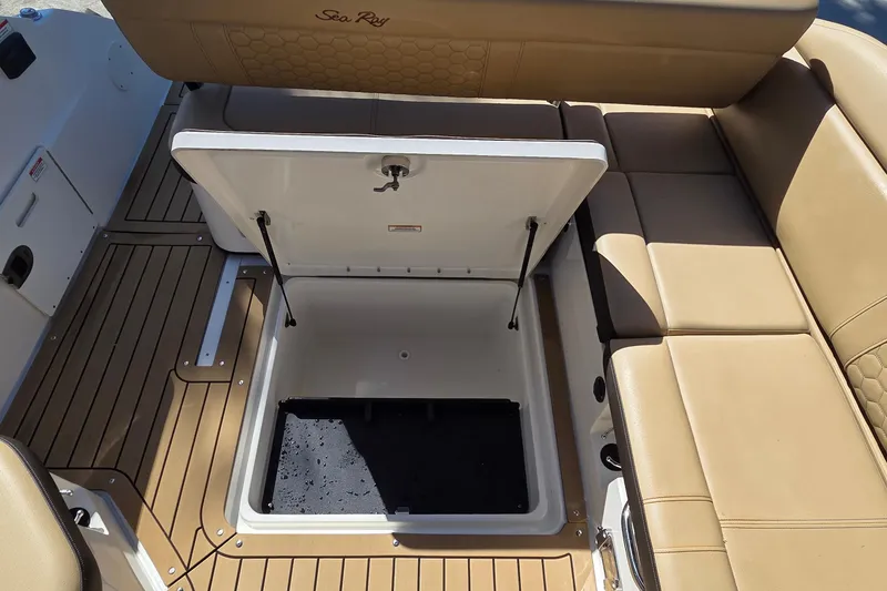 Slide: The Image of 2020 Sea Ray SDX 250 Outboard boat with open storage compartment and tan seating. - 26