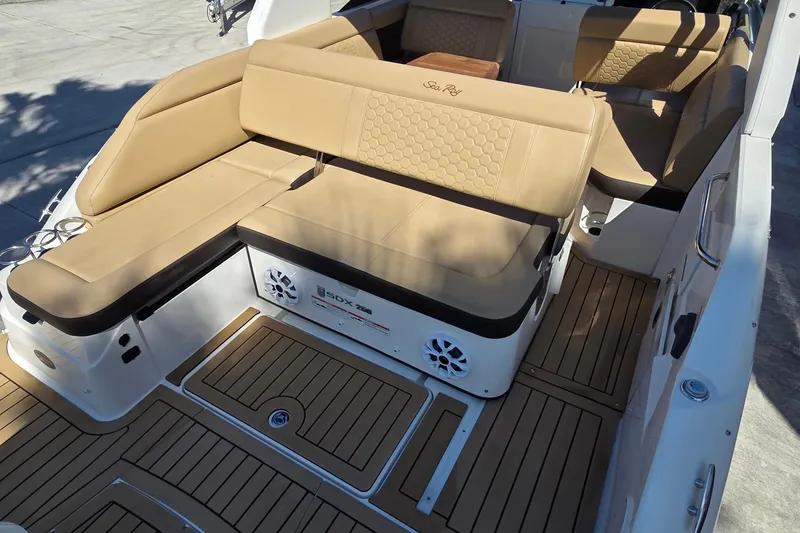 Slide: The Image of 2020 Sea Ray SDX 250 Outboard interior with tan seating and teak flooring. - 27