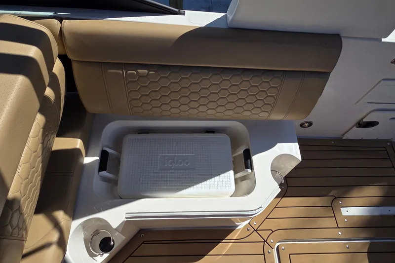 Slide: The Image of 2020 Sea Ray SDX 250 Outboard boat interior with Igloo cooler and tan seating. - 34