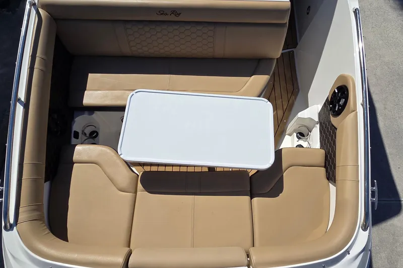 Slide: The Image of 2020 Sea Ray SDX 250 Outboard boat interior with tan seating and white table. - 37