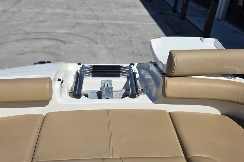 Slide: The Image of 2020 Sea Ray SDX 250 Outboard boat interior with tan seating and metal fittings. - 39