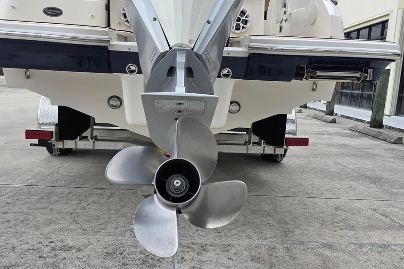 Slide: The Image of 2020 Sea Ray SDX 250 Outboard boat propeller and stern view on trailer. - 7