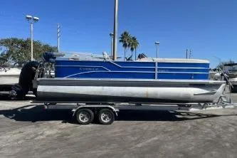 The Image of 2022 Cypress Cay Seabreeze 232 pontoon boat on trailer, parked outdoors. - 1