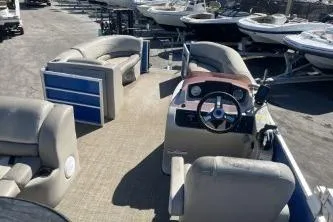 Slide: The Image of 2022 Cypress Cay Seabreeze 232 pontoon boat interior with seating and steering console. - 10