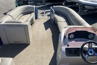 Slide: The Image of 2022 Cypress Cay Seabreeze 232 pontoon boat interior with seating and steering console. - 12