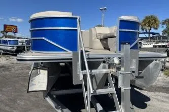 Slide: The Image of 2022 Cypress Cay Seabreeze 232 pontoon boat with blue accents, docked outdoors. - 3