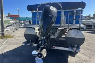 Slide: The Image of 2022 Cypress Cay Seabreeze 232 pontoon boat with outboard motor, docked on a sunny day. - 6