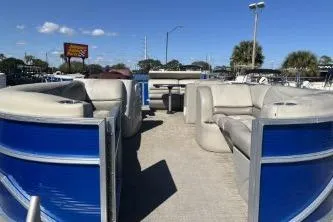 Slide: The Image of 2022 Cypress Cay Seabreeze 232 pontoon boat with blue panels and beige seating. - 7