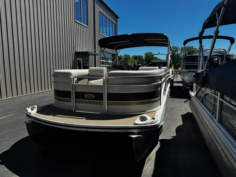 Slide: The Image of 2006 Harris Classic 240 I/O pontoon boat in front of a building. - 3