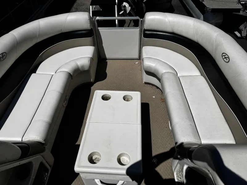 Slide: The Image of Interior of a 2006 Harris Classic 240 I/O pontoon boat with white seating. - 5