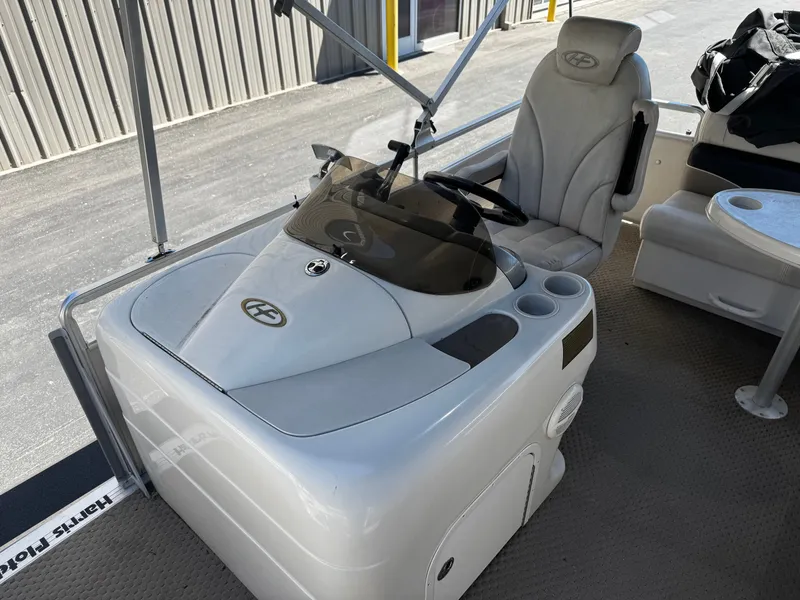Slide: The Image of 2006 Harris Classic 240 I/O boat helm with seating area. - 8