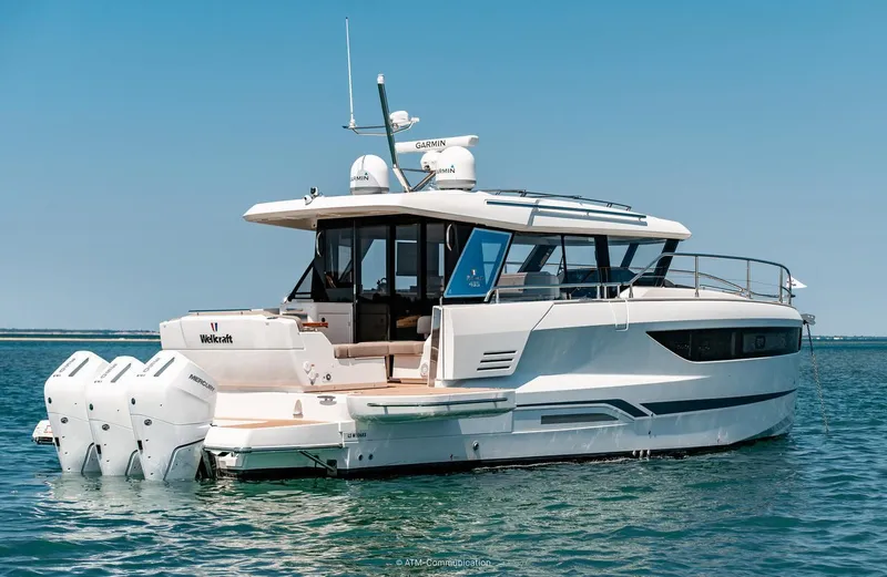 Slide: The Image of 2026 Wellcraft 44 Explorer yacht on calm blue water, rear view. - 3