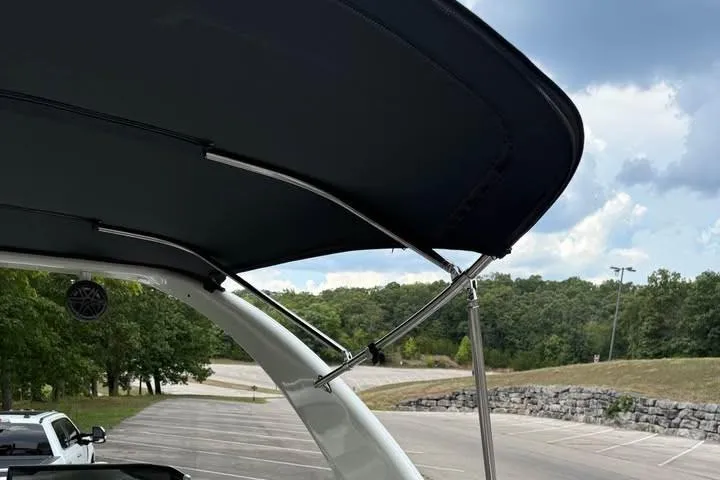 Slide: The Image of 2019 Berkshire 29 Sport RFX-DC boat with canopy in a parking lot. - 10