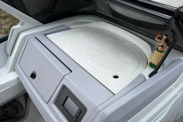 Slide: The Image of 2019 Berkshire 29 Sport RFX-DC boat interior with storage compartment and dashboard. - 13