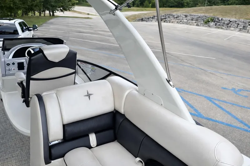 Slide: The Image of 2019 Berkshire 29 Sport RFX-DC boat interior with luxurious seating in a parking lot. - 7