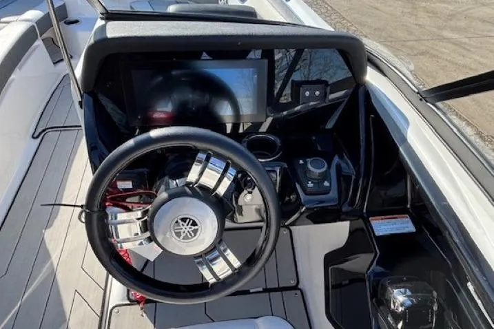 Slide: The Image of 2021 Yamaha Boats 212XD dashboard with steering wheel and touchscreen display. - 15