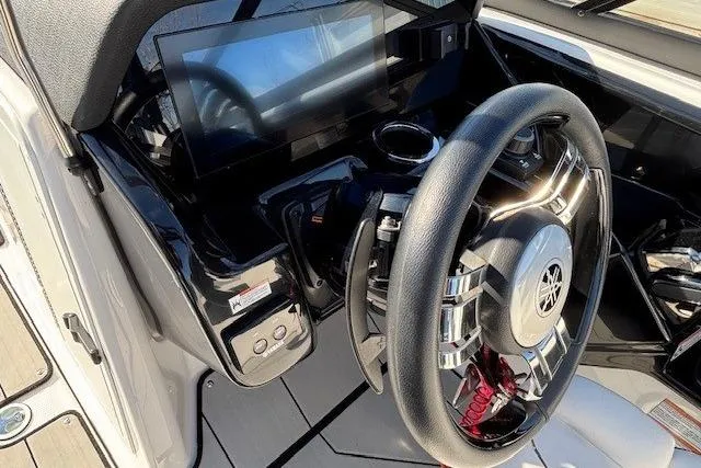 Slide: The Image of 2021 Yamaha Boats 212XD dashboard with steering wheel and touchscreen display. - 16