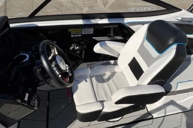 Slide: The Image of 2021 Yamaha Boats 212XD cockpit with modern steering and comfortable seating. - 17