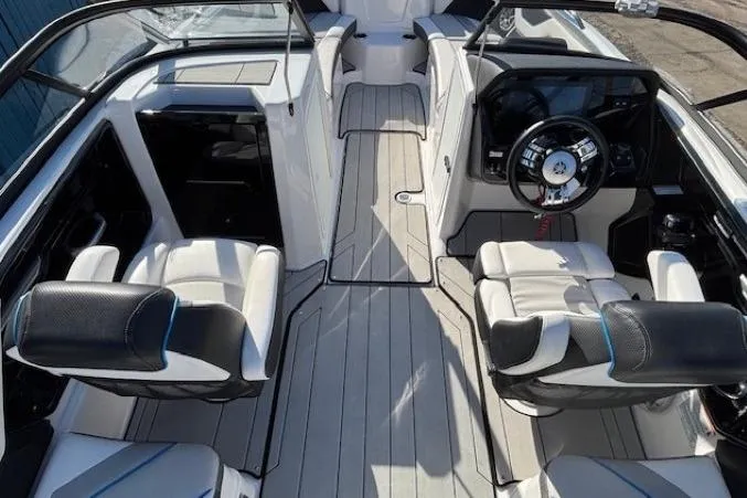 Slide: The Image of 2021 Yamaha Boats 212XD interior with sleek seating and modern dashboard design. - 22