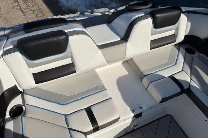 Slide: The Image of 2021 Yamaha Boats 212XD interior seating with black and white upholstery, featuring blue accents. - 30