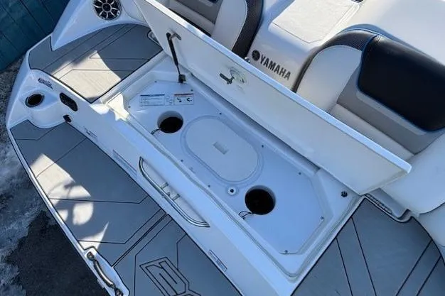 Slide: The Image of 2021 Yamaha Boats 212XD storage compartment open, showcasing interior design and features. - 34