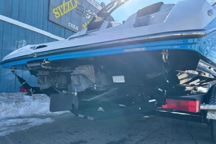 Slide: The Image of 2021 Yamaha Boats 212XD on trailer, rear view, blue and white design. - 4