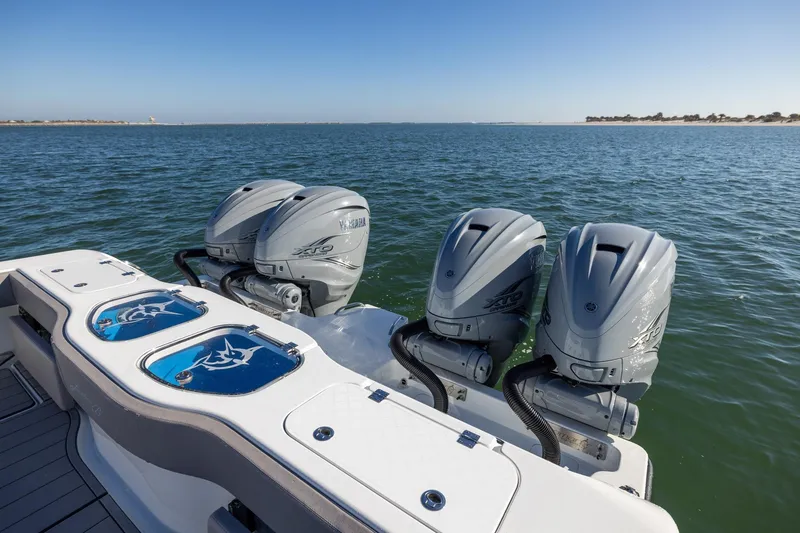 Slide: The Image of 2024 Freeman 47 boat with triple Yamaha outboard engines on open water. - 11