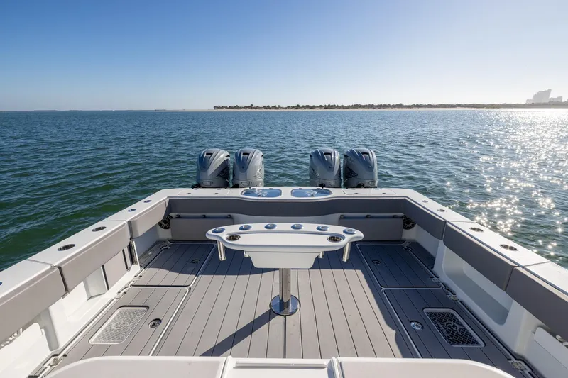 Slide: The Image of 2024 Freeman 47 boat deck with four engines on open water. - 12
