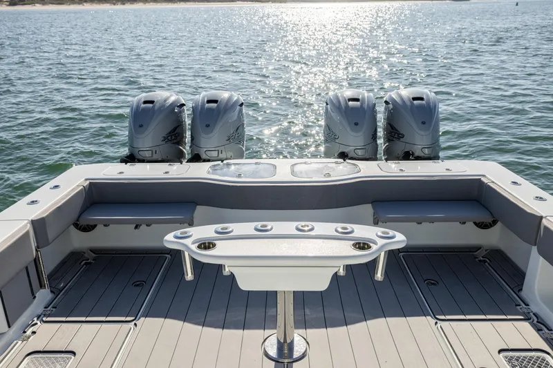 Slide: The Image of 2024 Freeman 47 boat with four powerful outboard engines on calm water. - 13