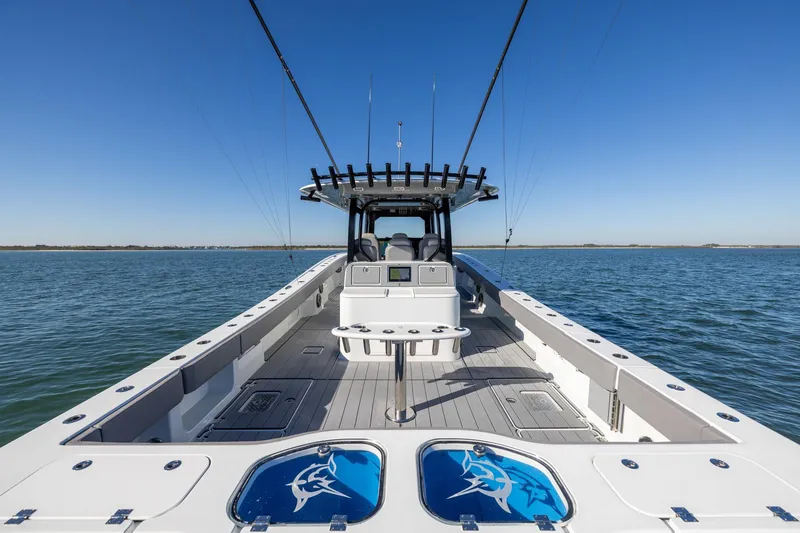 Slide: The Image of 2024 Freeman 47 boat on open water, featuring spacious deck and fishing equipment. - 14