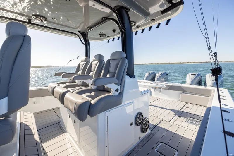 Slide: The Image of 2024 Freeman 47 boat interior with luxurious seating and multiple outboard engines on open water. - 24