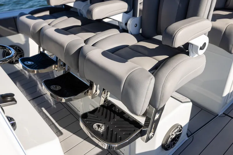 Slide: The Image of Luxury seating on 2024 Freeman 47 boat with gray upholstery and footrests. - 26