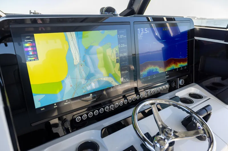 Slide: The Image of Dashboard of 2024 Freeman 47 boat with dual Garmin navigation screens. - 28