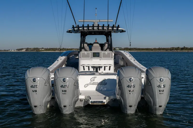 Slide: The Image of 2024 Freeman 47 boat with four powerful outboard engines on open water. - 3