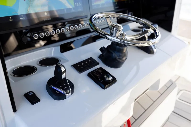 Slide: The Image of Control panel of 2024 Freeman 47 boat with steering wheel and navigation display. - 30