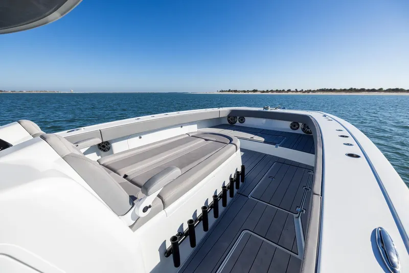 Slide: The Image of 2024 Freeman 47 boat interior with sleek seating, ocean view, and clear blue sky. - 36