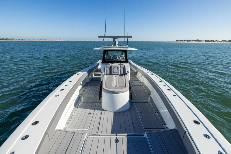 Slide: The Image of 2024 Freeman 47 boat cruising on open water under clear blue skies. - 38