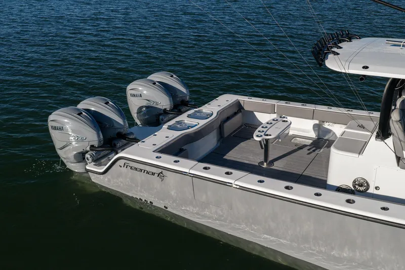 Slide: The Image of 2024 Freeman 47 boat with Yamaha engines on calm water. - 4