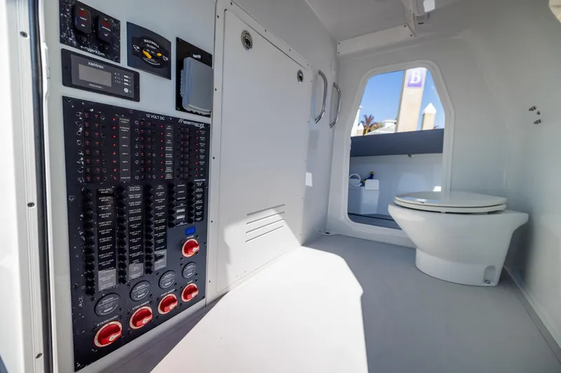 Slide: The Image of 2024 Freeman 47 boat interior with control panel and marine toilet. - 47