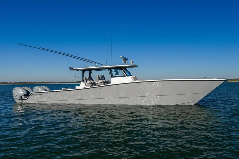 Slide: The Image of 2024 Freeman 47 boat on calm water under clear blue sky. - 5