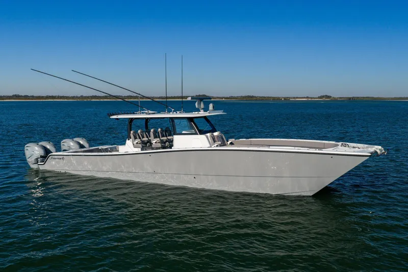 Slide: The Image of 2024 Freeman 47 boat on calm blue water under clear sky. - 6