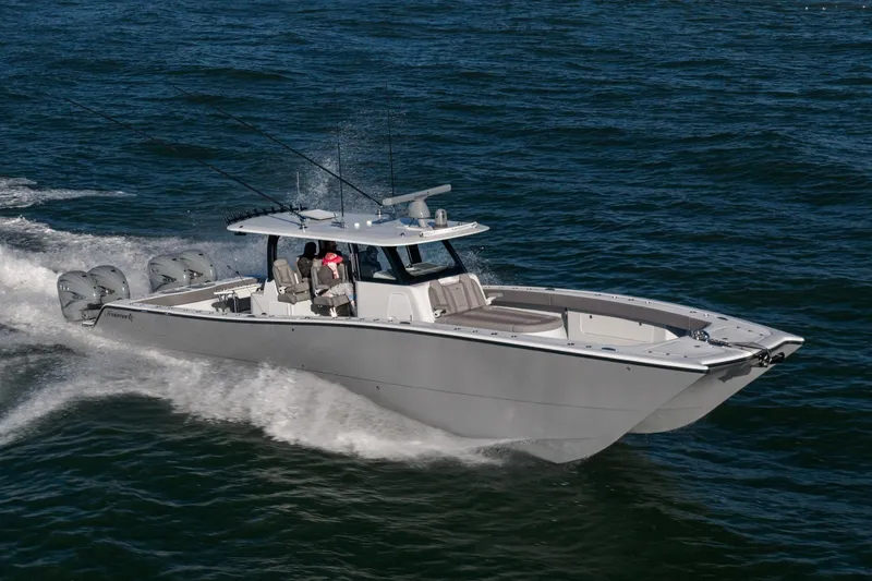Slide: The Image of 2024 Freeman 47 boat cruising on open water with multiple outboard engines. - 7