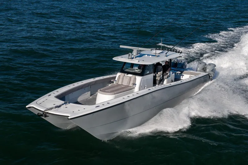 Slide: The Image of 2024 Freeman 47 boat cruising on open water, showcasing sleek design and powerful engines. - 8