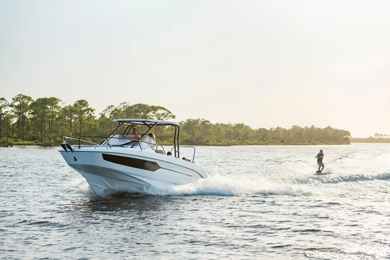 Slide: The Image of 2026 Beneteau Flyer 8 SUNdeck cruising with a wakeboarder on a sunny day. - 10